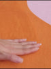 Fingers glide over the Designer Irregular Orange Moss Rug, its soft, plush